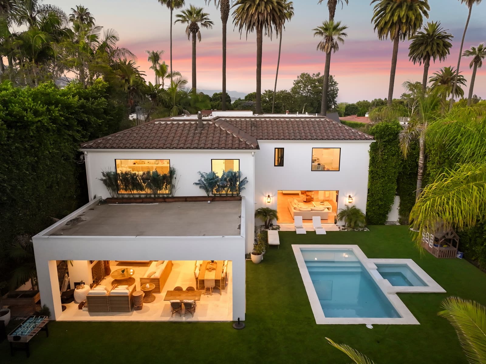 Drone twilight over a Beverly Hills home, pool lit