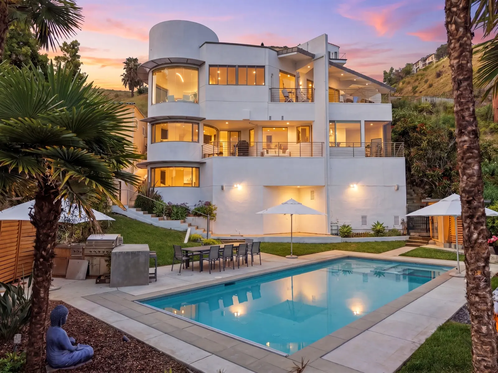 Malibu three-story home and pool at twilight